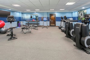 A gym with cardio machines, free weights, and exercise balls. - Four Points by Sheraton Bentonville (Bentonville)