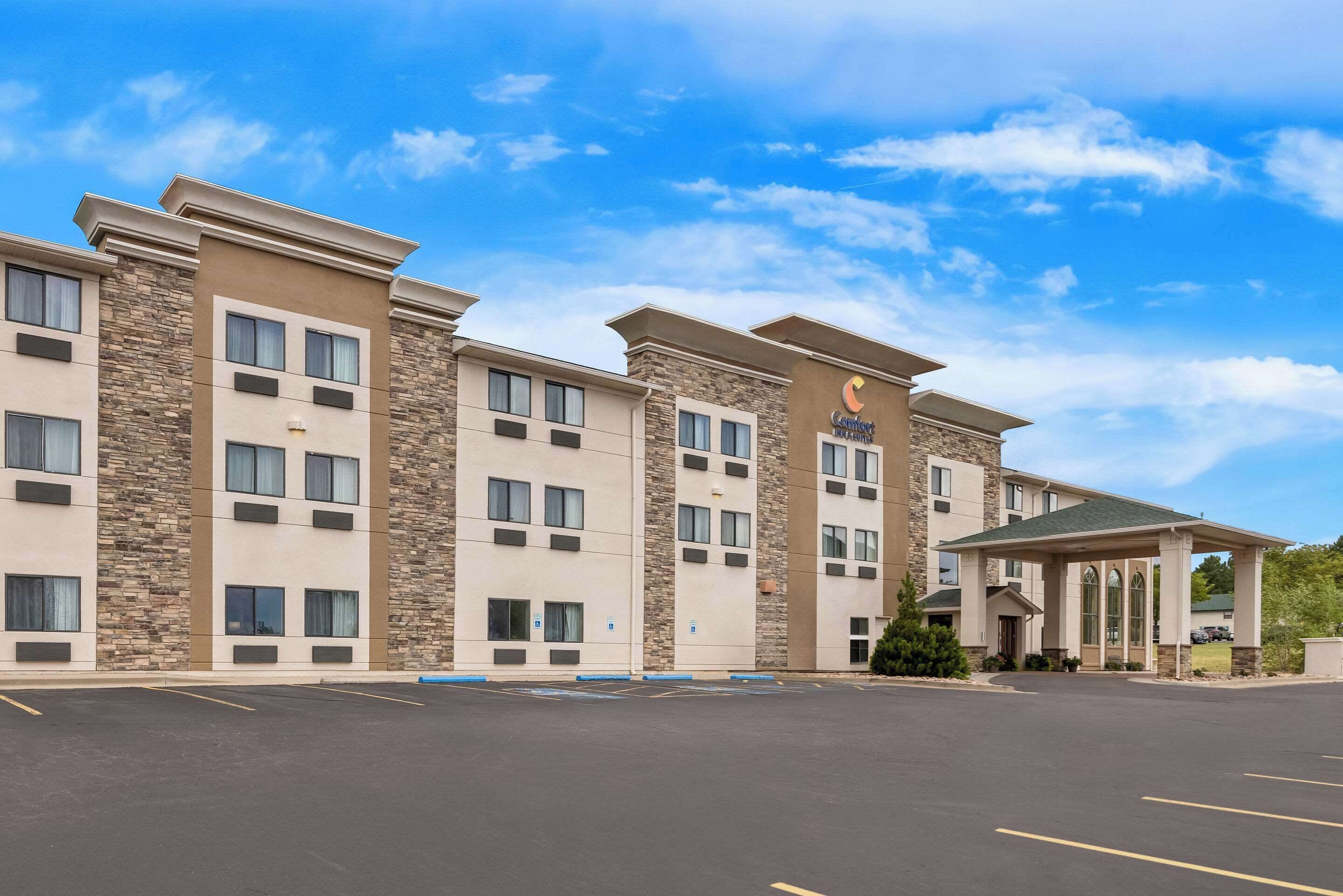 A hotel with a modern design, featuring a stone facade and multiple windows.