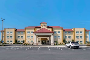A Comfort Inn hotel with a red roof, multiple floors, and a parking lot.