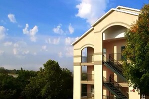 A multi-story building with balconies and a staircase. - The Park at Foxborough Resort (Branson)