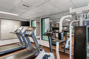 A gym with treadmills, a stationary bike, and weight machines.