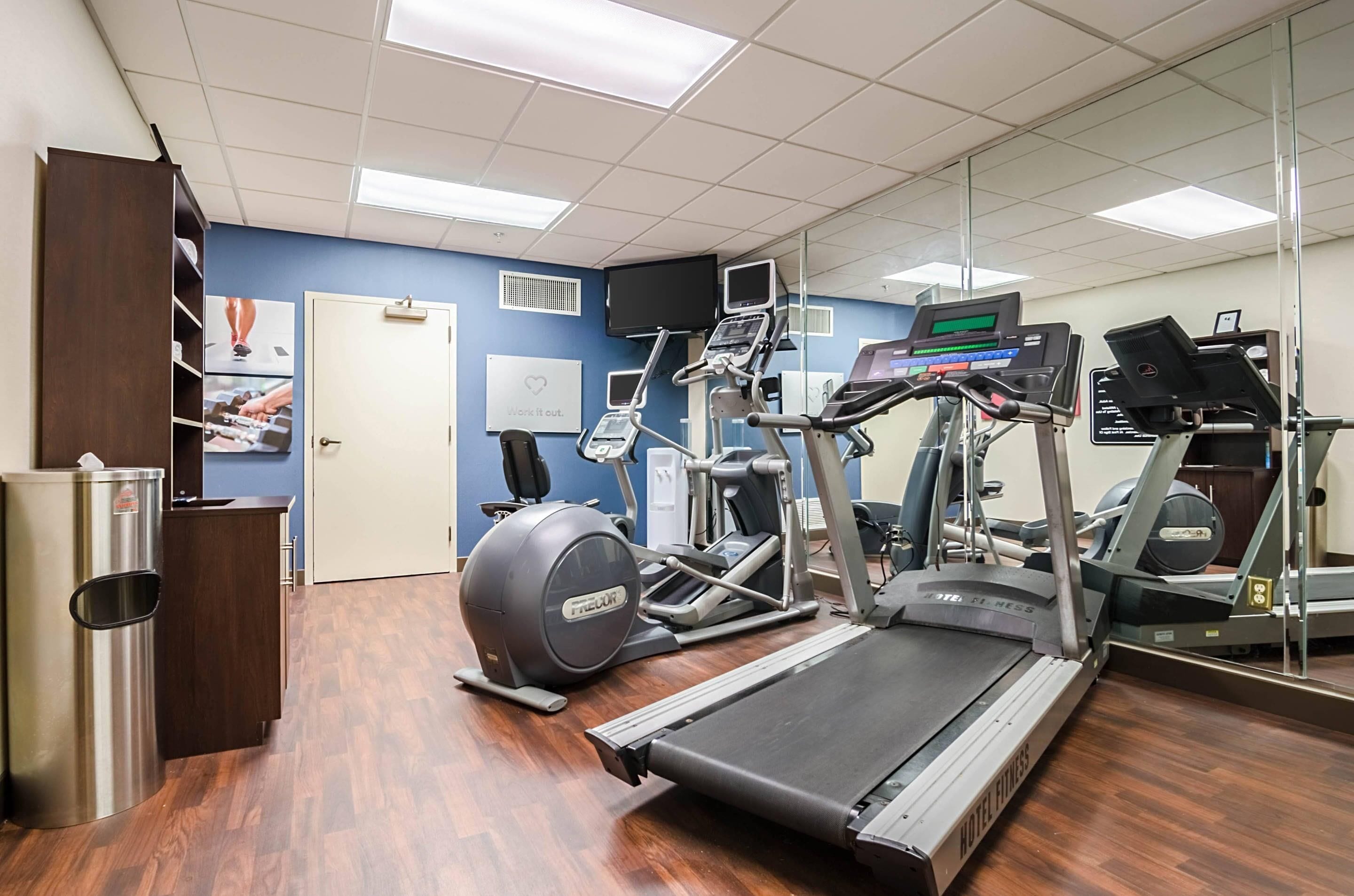 A gym with treadmills, an elliptical, and a stationary bike.
