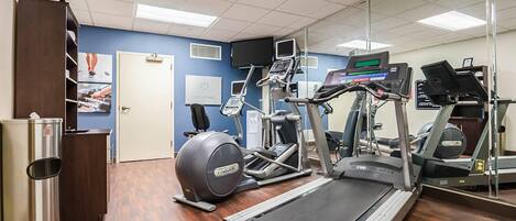 A gym with treadmills, an elliptical, and a stationary bike.