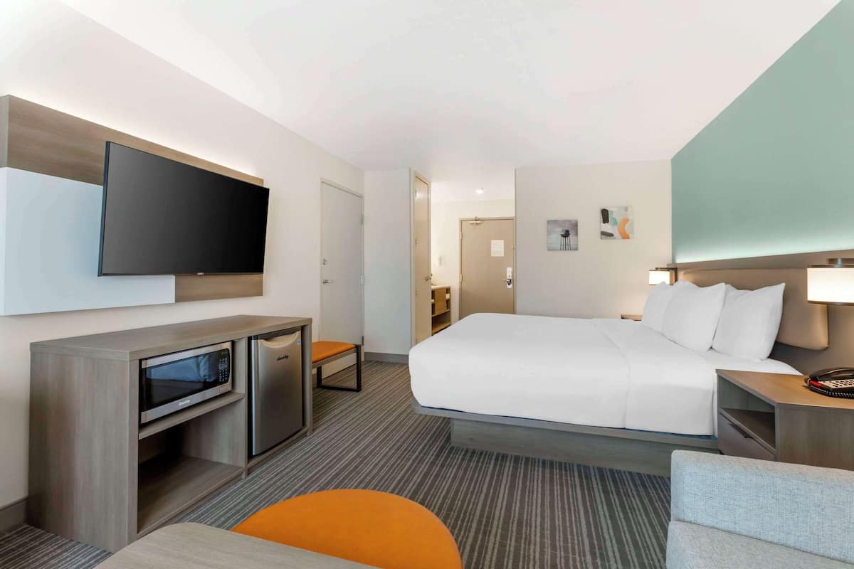 Premium bedding, desk, laptop workspace, blackout drapes