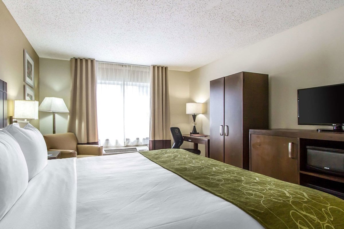 Premium bedding, desk, laptop workspace, blackout drapes