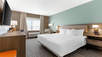 Premium bedding, desk, laptop workspace, blackout curtains