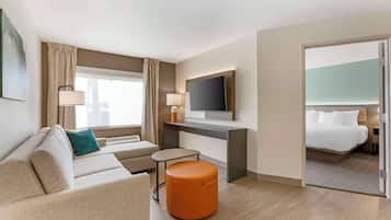 Premium bedding, desk, laptop workspace, blackout drapes