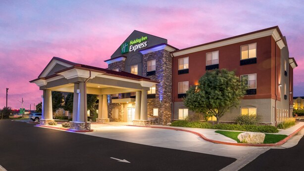 A Holiday Inn Express hotel with a covered entrance, stone facade, and a well-lit parking area. - Holiday Inn Express Hotel & Suites Limon I-70 by IHG (Limon)