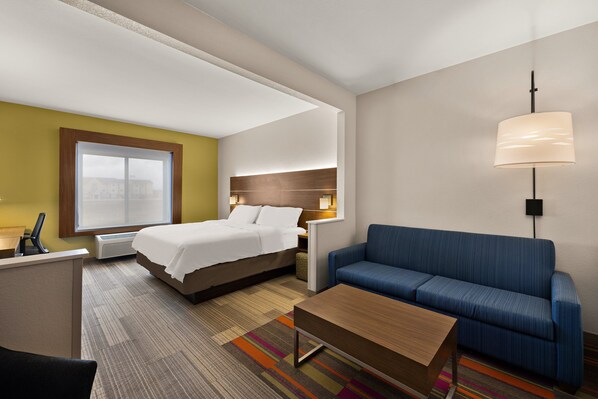 A hotel room with a bed, a sofa, a desk, and a lamp. - Holiday Inn Express Hotel & Suites Limon I-70 by IHG (Limon)