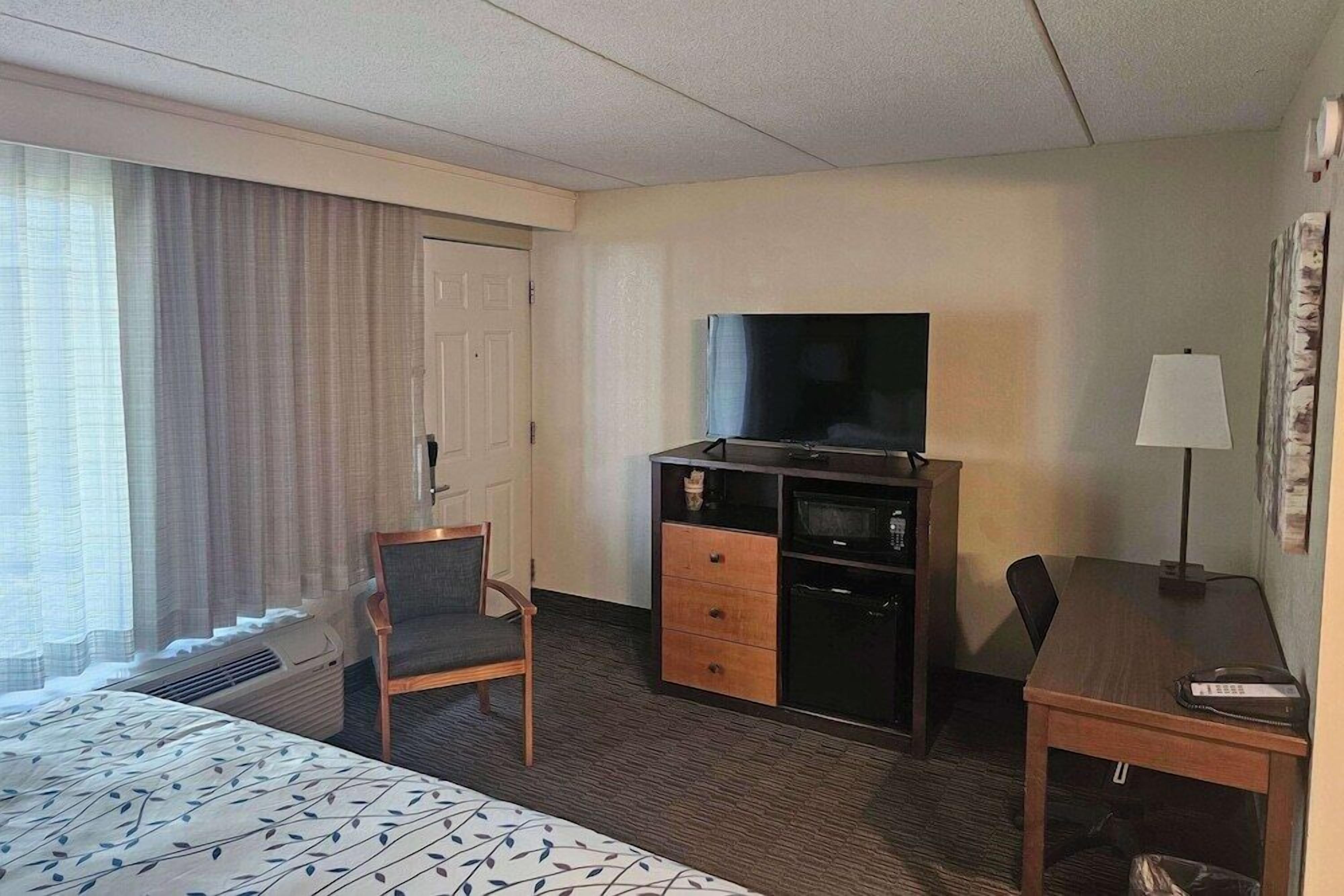 Desk, laptop workspace, blackout drapes, iron/ironing board