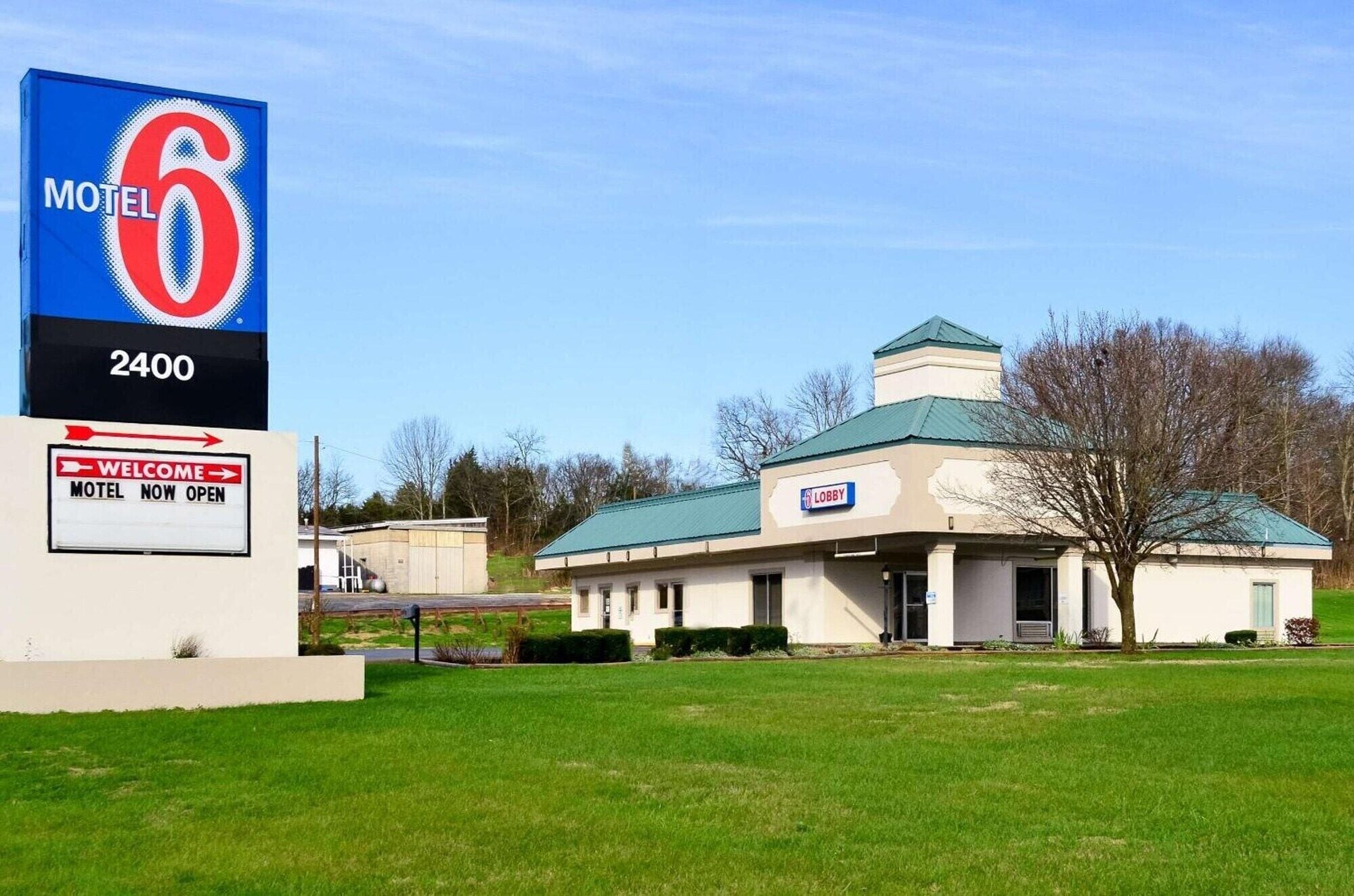 A motel with a large sign indicating it is number 6 and located at 2400.