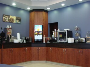 Enjoy a convenient coffee station with a coffee machine, juice dispenser, and waffle maker.