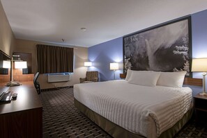 Relax in comfort with a large bed, desk, and chair, plus a convenient air conditioning unit.