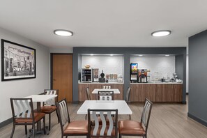 A modern dining area with a counter and seating. - Super 8 by Wyndham Chattanooga East/Hamilton Place (Chattanooga)