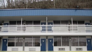 A two-story motel with numbered doors and balconies. - Motel 6 Chilhowie, VA  I-81 (Chilhowie)
