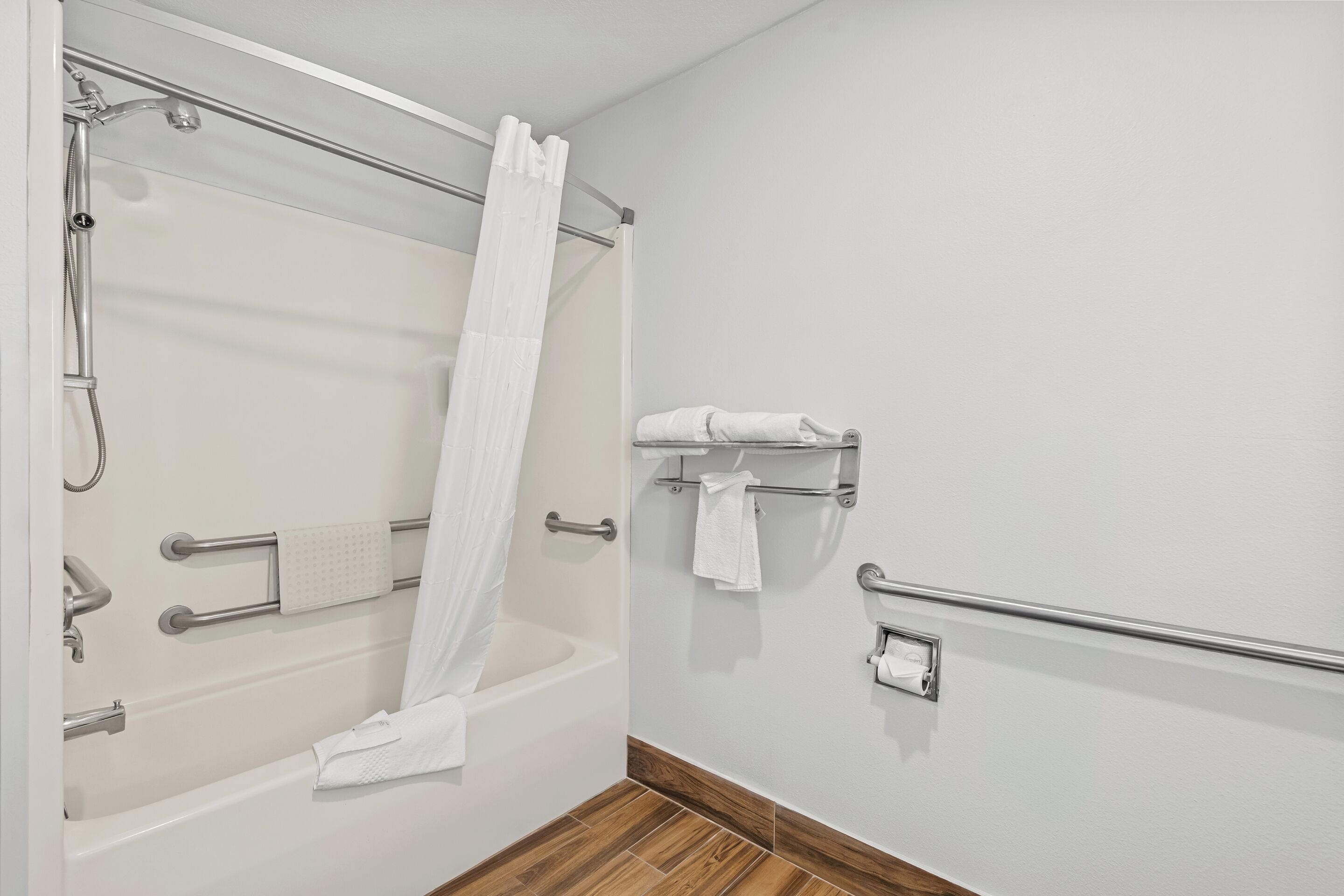 A bathroom with a bathtub, a shower, and a toilet.