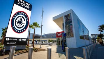 A modern building with a prominent sign for the Los Angeles Clippers, a Pechanga Resort Casino, and AT&T.