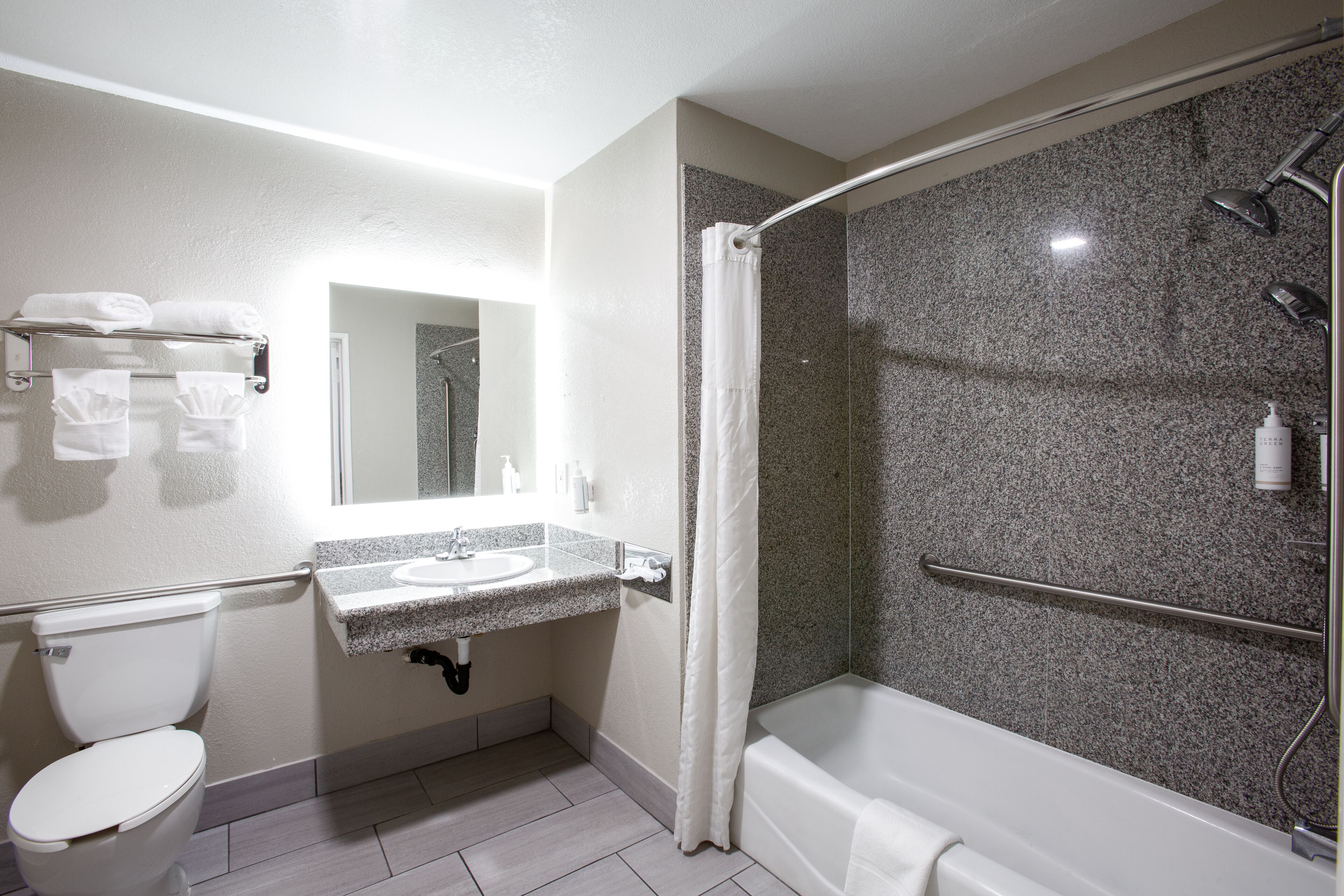 A modern bathroom with a toilet, sink, and shower area.