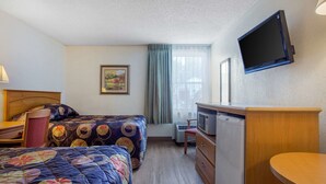 A hotel room with two beds, a TV, a desk, and a dresser. - Rodeway Inn Asheville (Asheville)