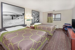 A hotel room with two beds, a desk, a TV, a large window with curtains, and artwork on the walls. - Super 8 by Wyndham Muscatine (Muscatine)
