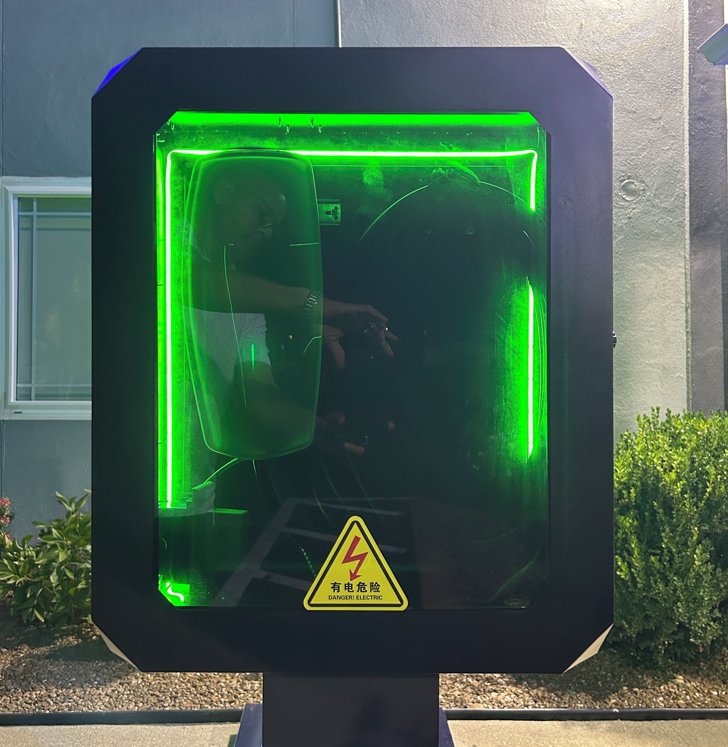 A safety warning sign with a reflective surface.