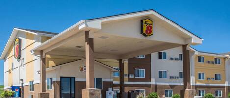 A Super 8 hotel with a covered parking area and multiple floors.
