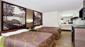 A hotel room with two beds, a desk, a TV, and artwork on the walls.