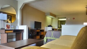 A hotel room with a bed, a desk, a television, and a mirror. - Super 8 by Wyndham Pigeon Forge Dollywood Lane (Pigeon Forge)