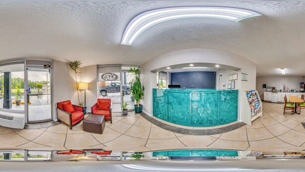 A spacious living area with a pool, a kitchen, and a reception desk. - Rodeway Inn Dalton South (Dalton)