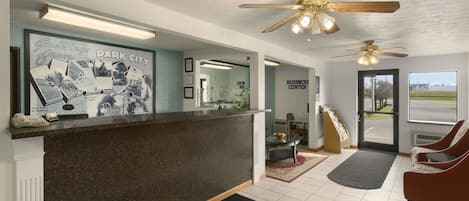 A reception area with a counter, ceiling fans, and a view of the outside.