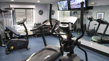 A gym with treadmills, a bench, and exercise equipment.