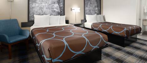 A hotel room with two beds, a blue chair, and a large painting on the wall.