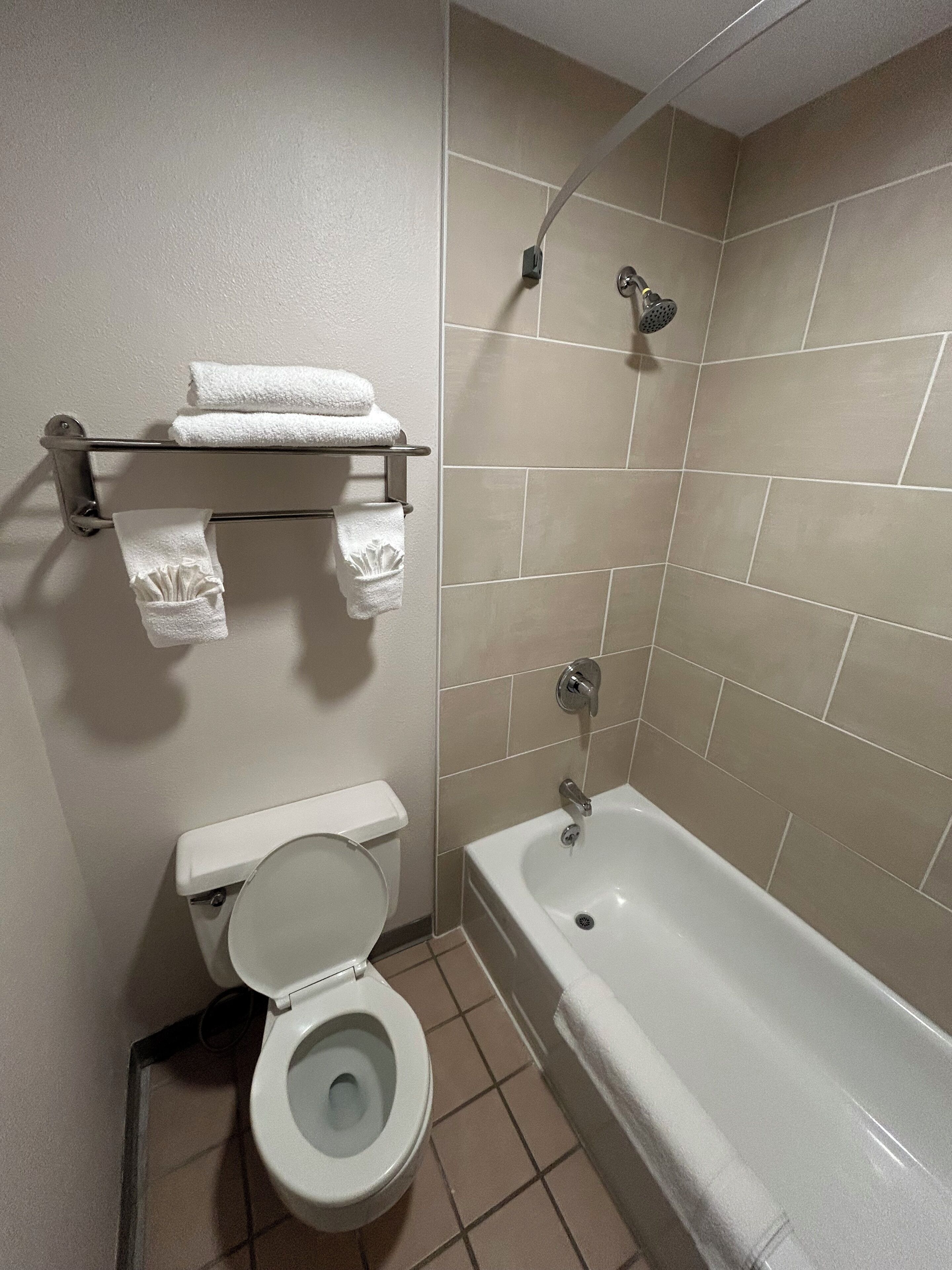 A bathroom with a toilet, a sink, and a bathtub.