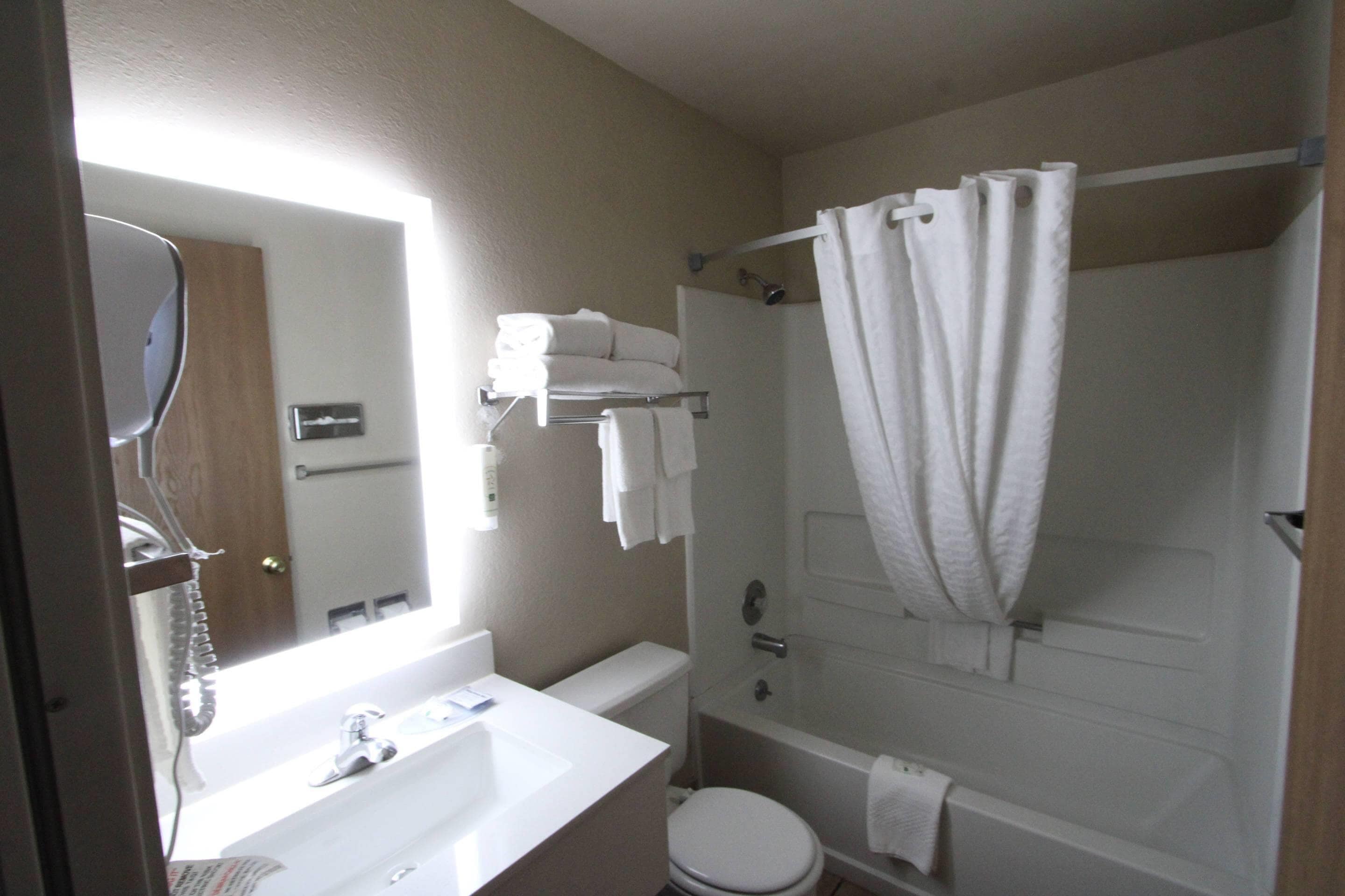 A bathroom with a sink, toilet, and shower.