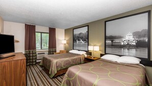 A hotel room with two beds, a TV, a window with curtains, and a large framed picture of a boat on the wall.