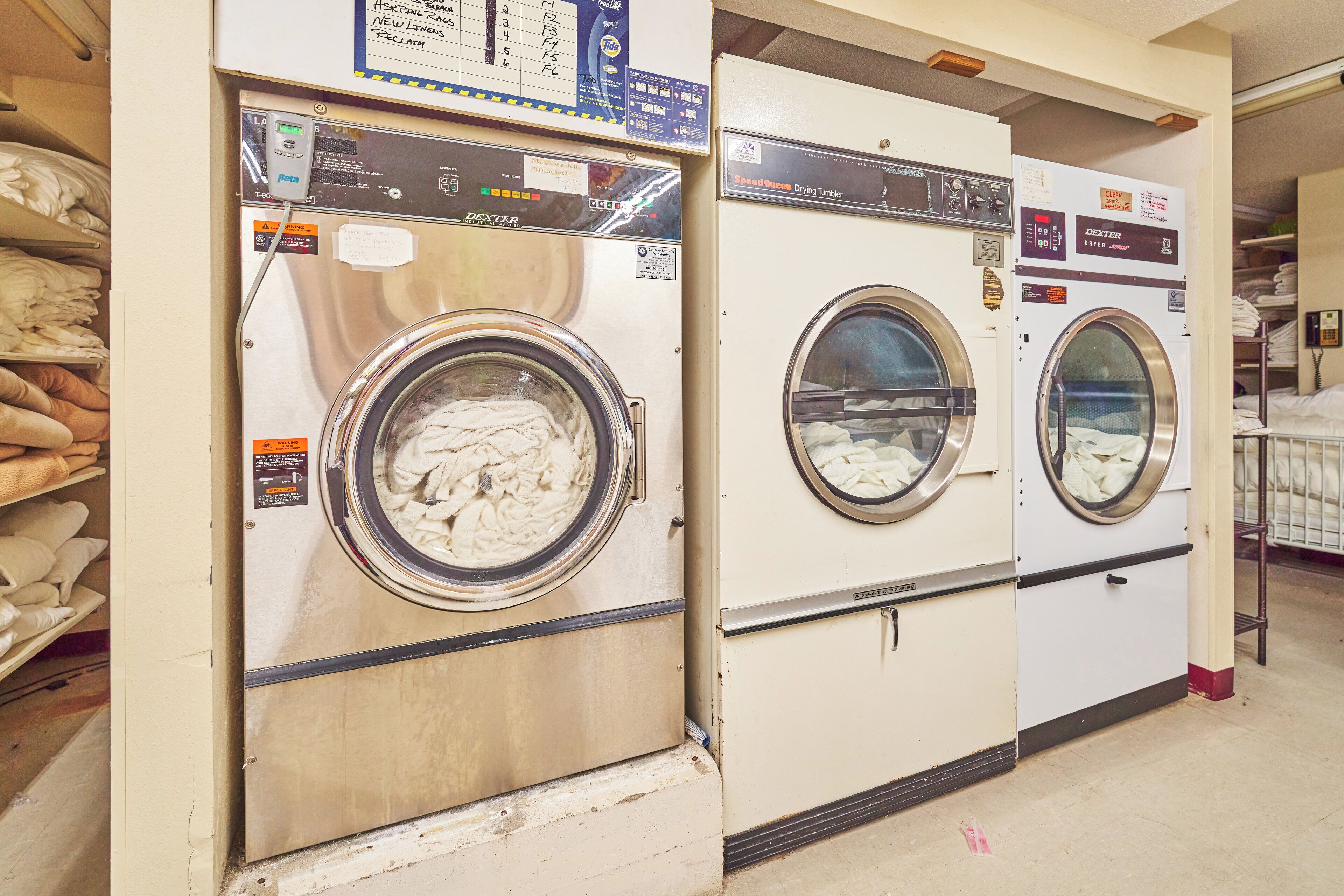 Two front-loading washing machines in a laundromat.