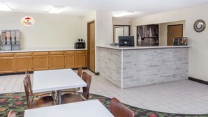 A breakfast area with a counter, seating, and a coffee machine. - Super 8 by Wyndham Pekin/Peoria Area (Pekin)