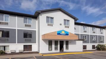 A Days Inn hotel with a modern design, featuring a flat roof, large windows, and a parking lot.