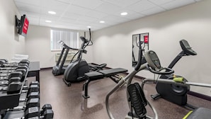 A gym with treadmills, elliptical machines, and dumbbells. - Red Roof Inn PLUS+ & Suites Malone (Malone)