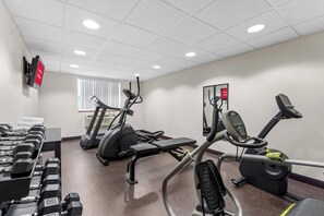 A gym with treadmills, elliptical machines, and dumbbells. - Red Roof Inn PLUS+ & Suites Malone (Malone)