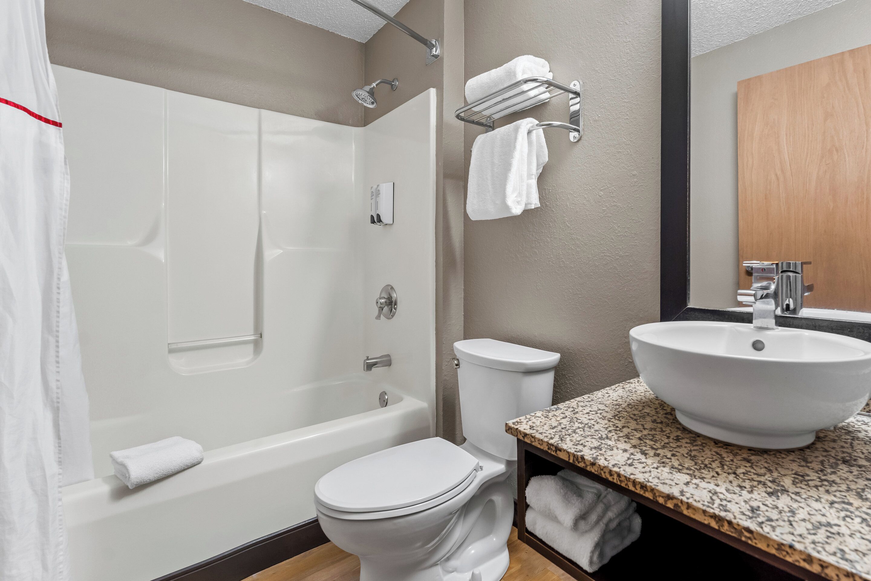 Un baño moderno con bañera, inodoro y lavamanos.