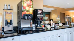 A self-service beverage station with options for apple juice, orange juice, and fresh coffee. - Quality Inn Noblesville - Indianapolis (Noblesville)