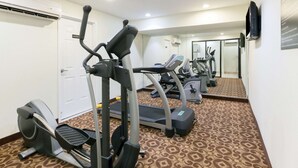 A gym with treadmills, elliptical machines, and a mirrored wall. - Super 8 by Wyndham Decatur/Dntn/Atlanta Area (Decatur)