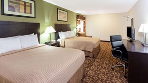 A hotel room with two beds, a desk, a chair, a TV, and a patterned carpet. - Super 8 by Wyndham Decatur/Dntn/Atlanta Area (Decatur)