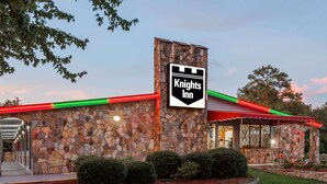 A Knights Inn with a stone facade, a red awning, and a signboard. - Knights Inn Columbia (Columbia)