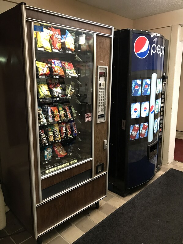 A vending machine with snacks and a Pepsi dispenser. - Corbin Inn (Corbin)
