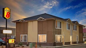 A Super 8 motel with a two-story structure, large windows, and a flat roof.