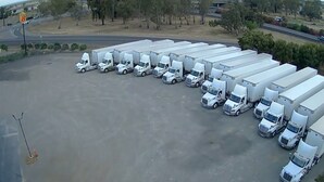 A large parking lot with multiple white trucks parked in an orderly fashion. - Deluxe Inn Willows (Willows)