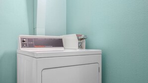 A white commercial dryer with a control panel and a box of dryer sheets on top. - Hotel Hamilton (Hamilton)
