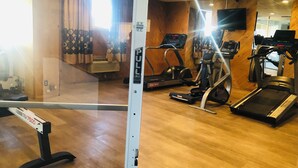 A gym with treadmills, elliptical machines, and a stationary bike. - Inn at the Highland Denver Downtown (Denver)